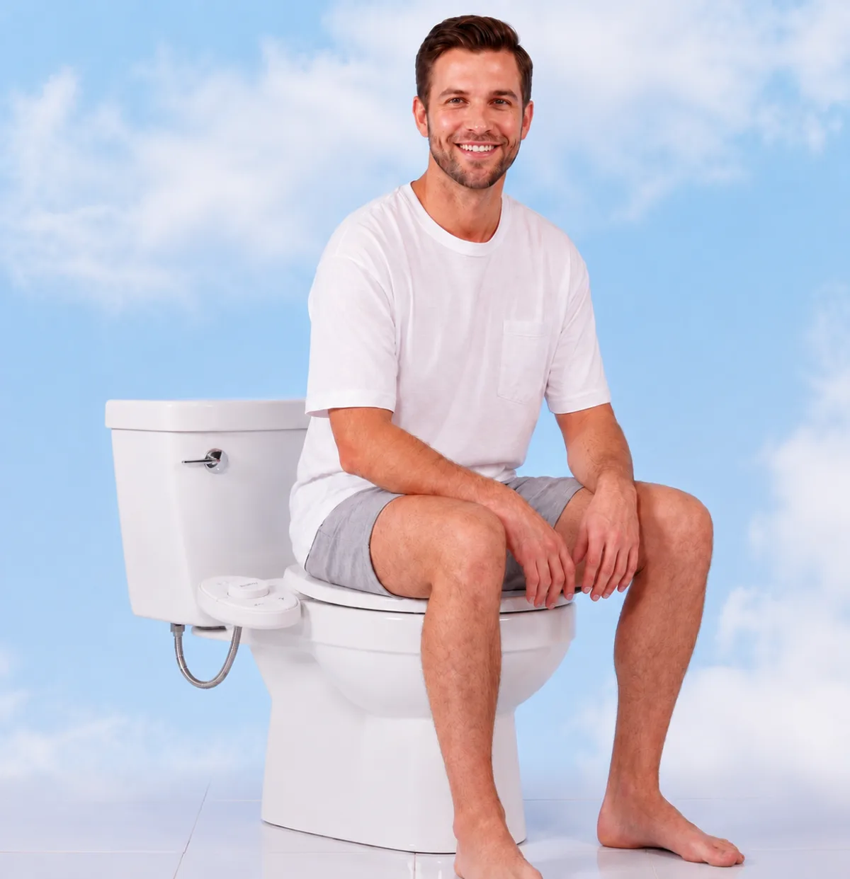 Person sitting on a toilet fitted with a Flushy bidet attachment